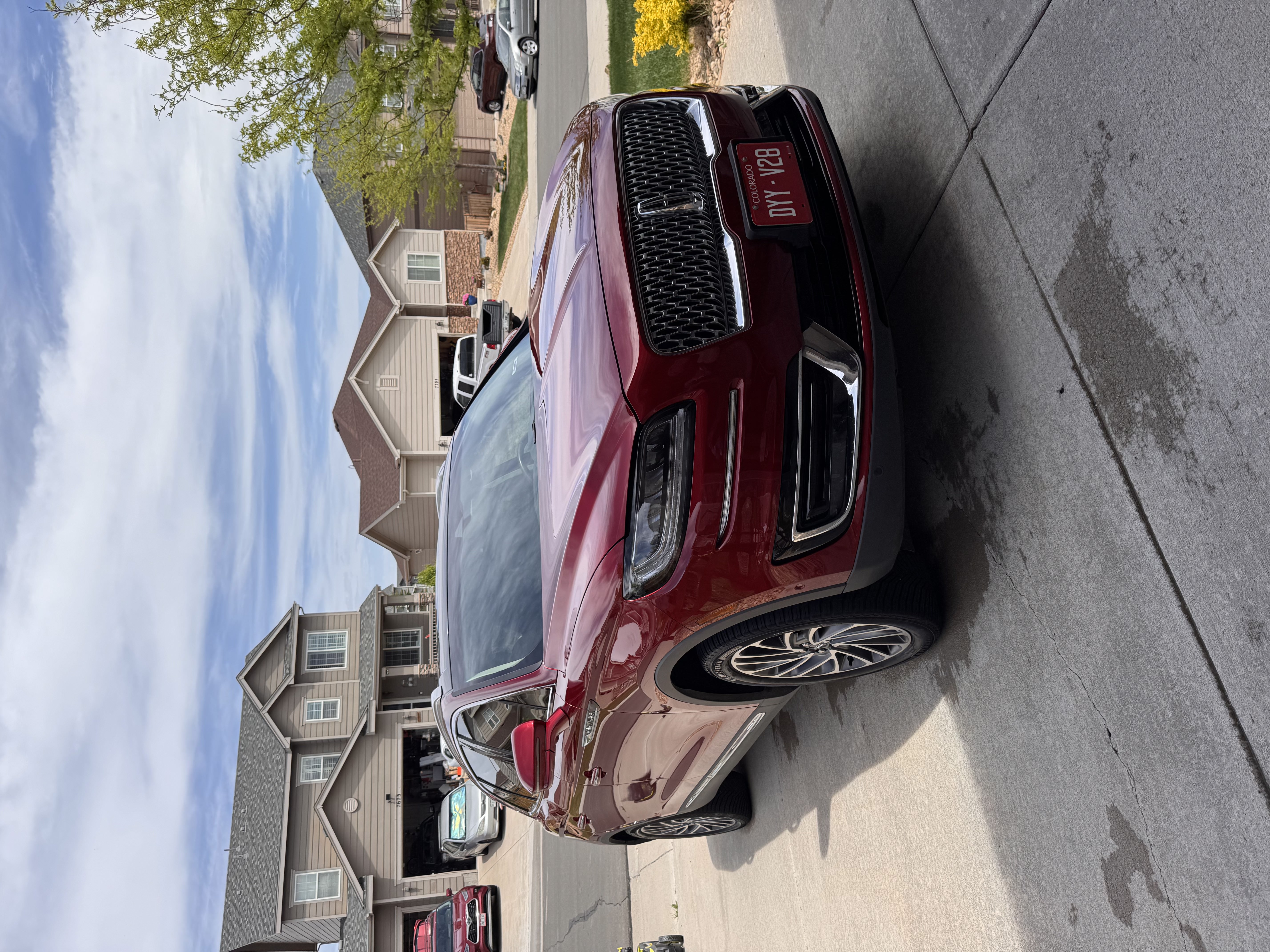 Red Lincoln SUV with a glossy finish after a full exterior detail and hand wax